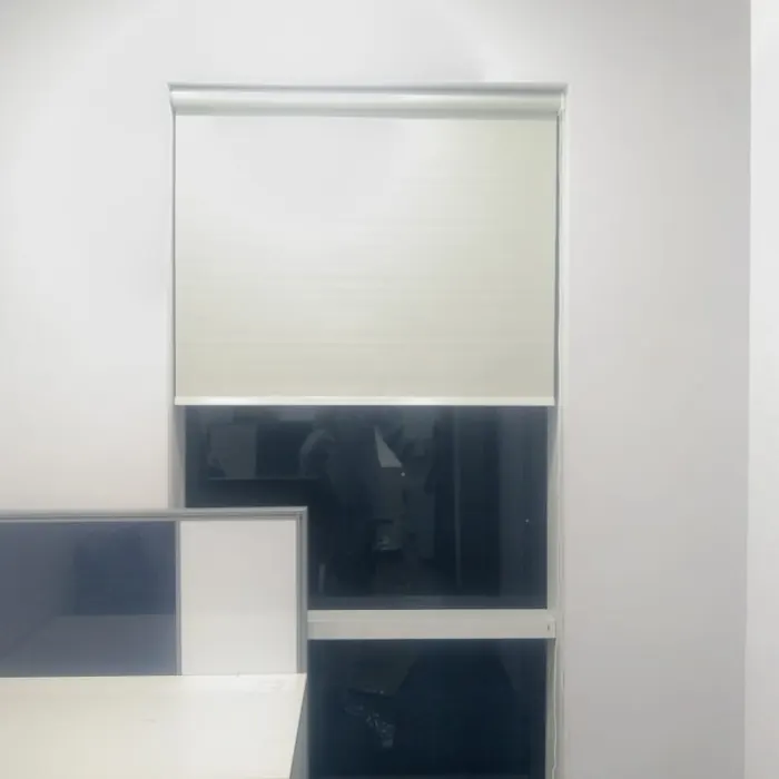 Pleated blind stacked above an office desk
