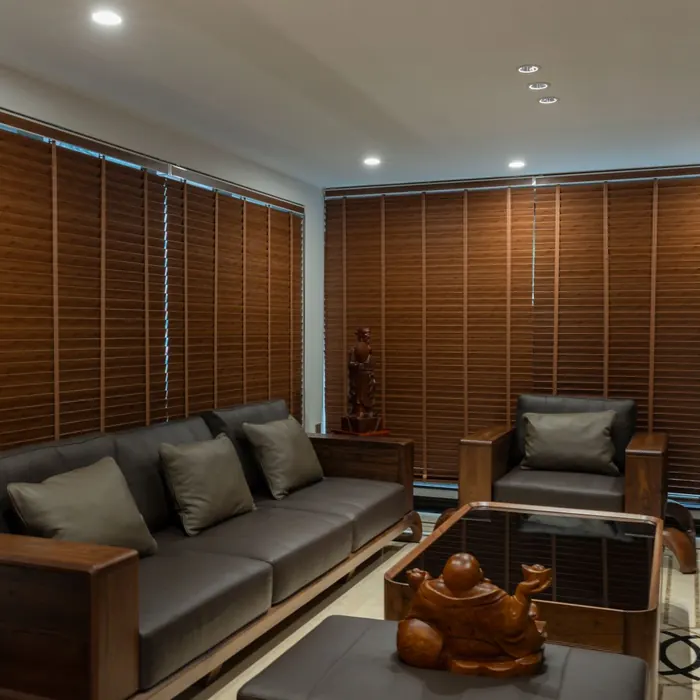 Wooden venetian blinds across a lounge window wall
