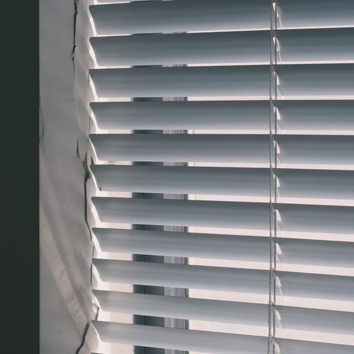White venetian blind lowered over a window