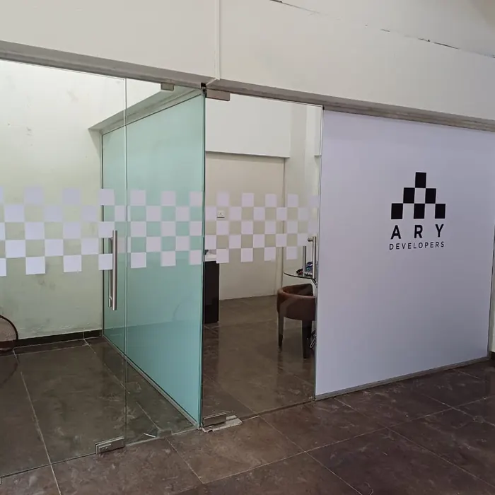 Developer branding printed across a glass office partition