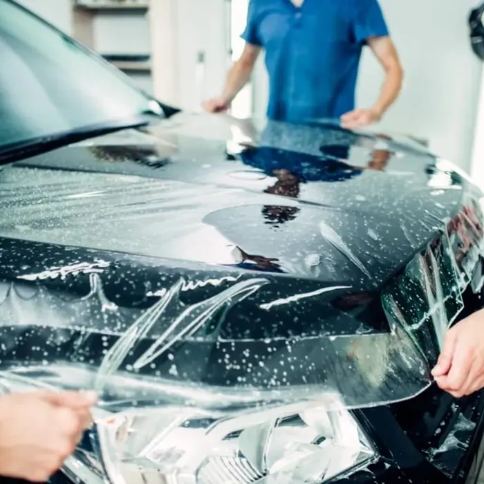 Clear paint protection film laid over a car bonnet