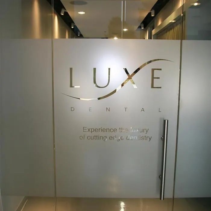 Dental clinic entrance with the practice name frosted onto the glass