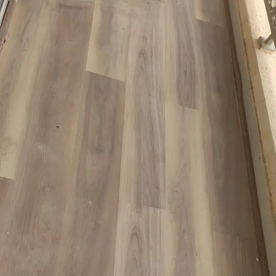 Plank flooring laid across a finished room