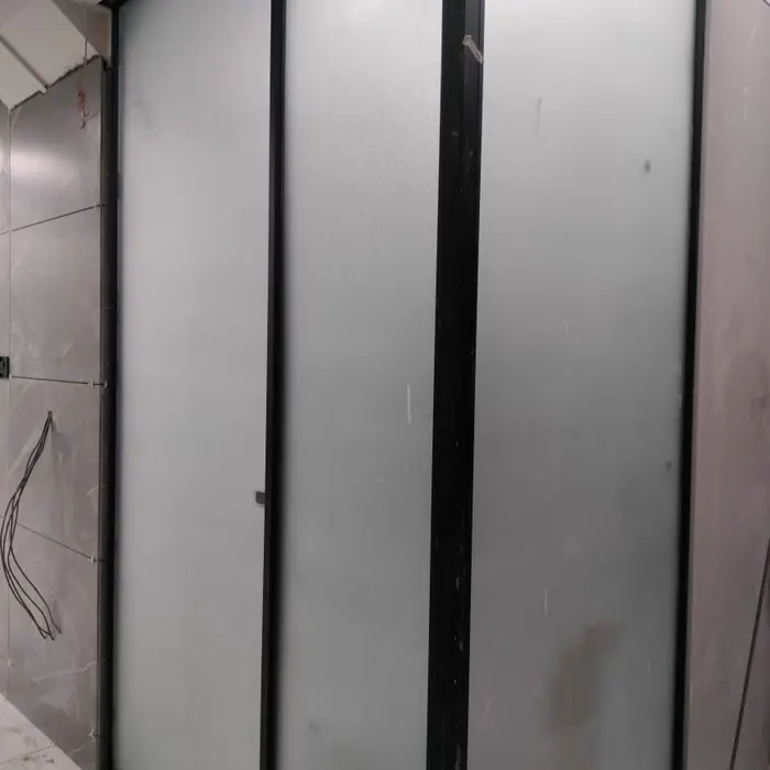 Black-framed glass partition frosted to full height