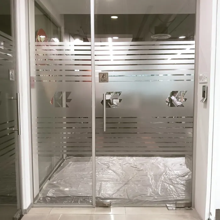 Toughened glass door with a striped frosted band