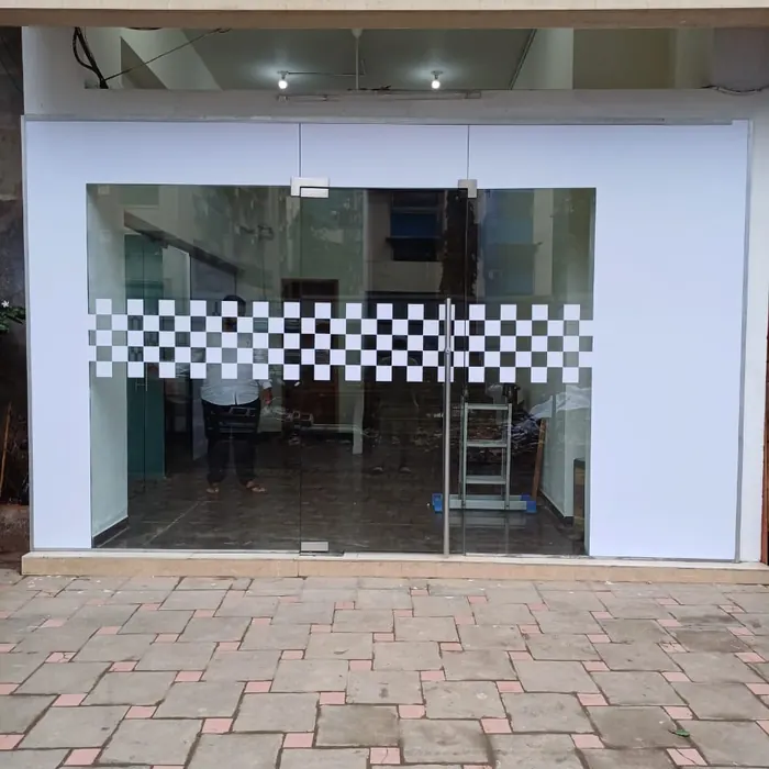 Glass shopfront with printed branding across the entrance
