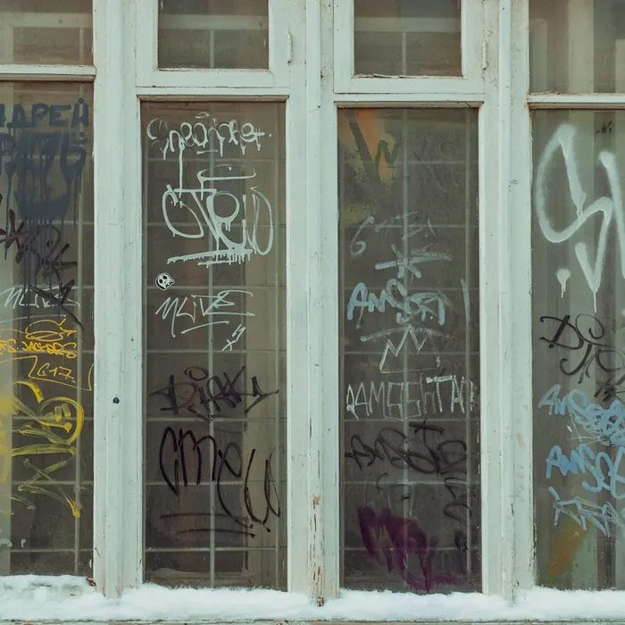 Shopfront glazing covered in spray-paint tags