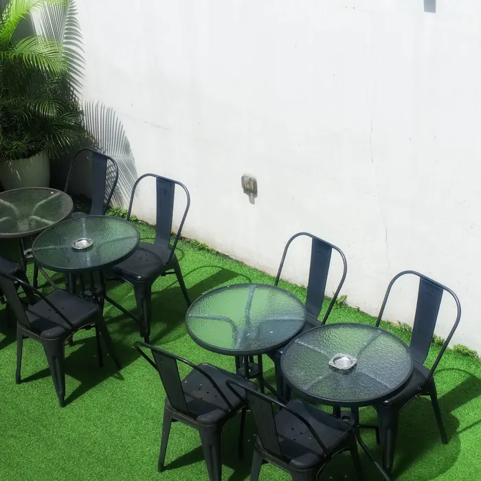 Cafe tables arranged on an artificial grass courtyard