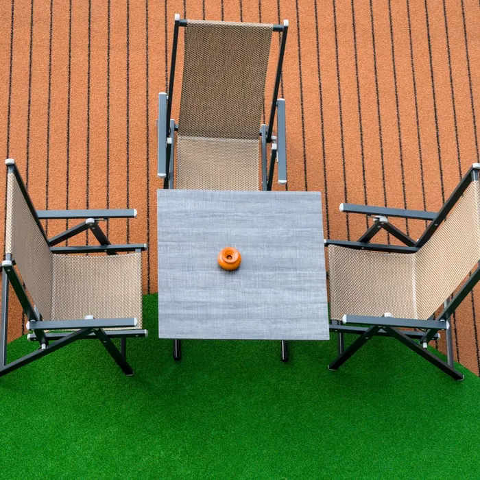 Patio seating set out on artificial grass