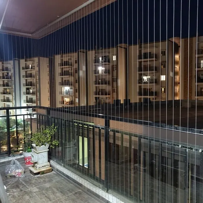 Invisible grille spanning a wide balcony rail