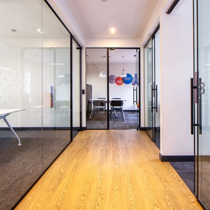 Glazed office corridor with patterned manifestation dots