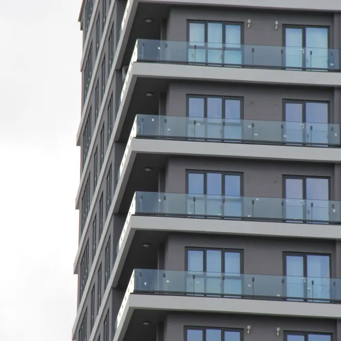 Stacked glass balconies on an apartment tower