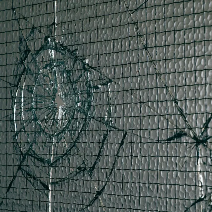 Shattered pane held together by embedded wire