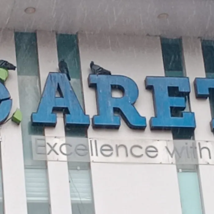 Raised 3D letters mounted on a striped fascia