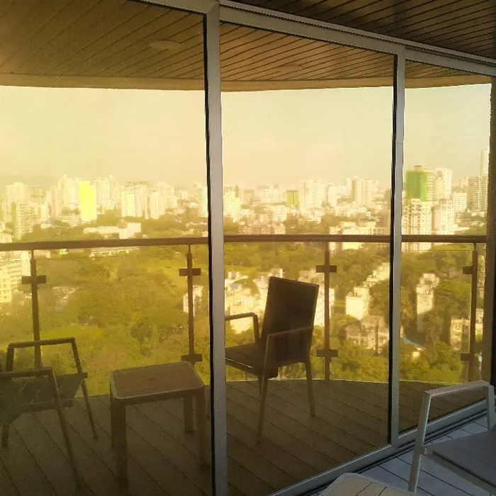 Bronze sun control film on wraparound balcony glazing