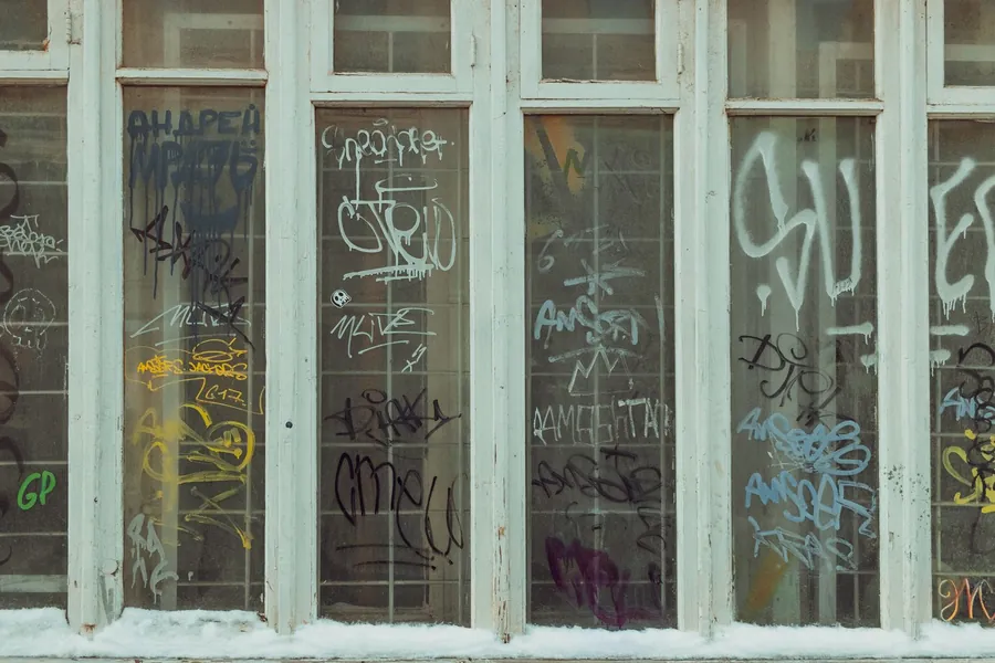 Shopfront glazing covered in spray-paint tags