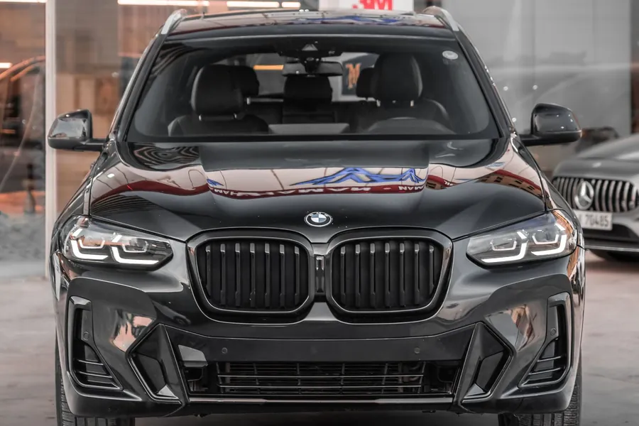 Front windshield of a car filmed and parked at a detailing bay