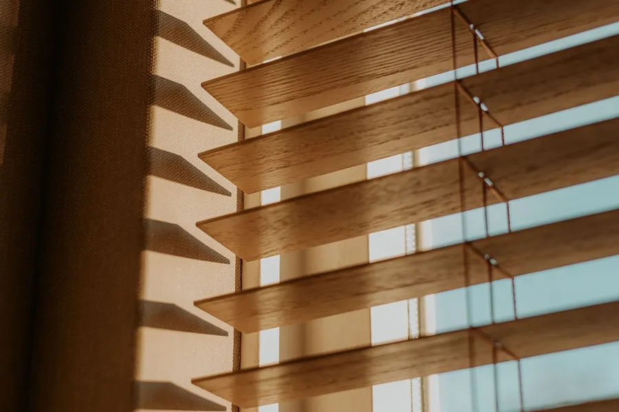 Wooden venetian slats filtering warm afternoon light