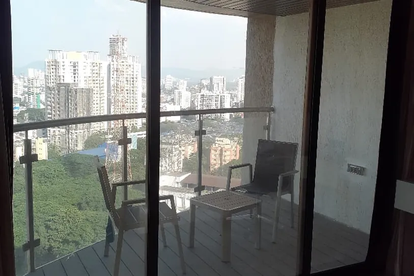 Balcony sliding doors filmed against a clear view of the city